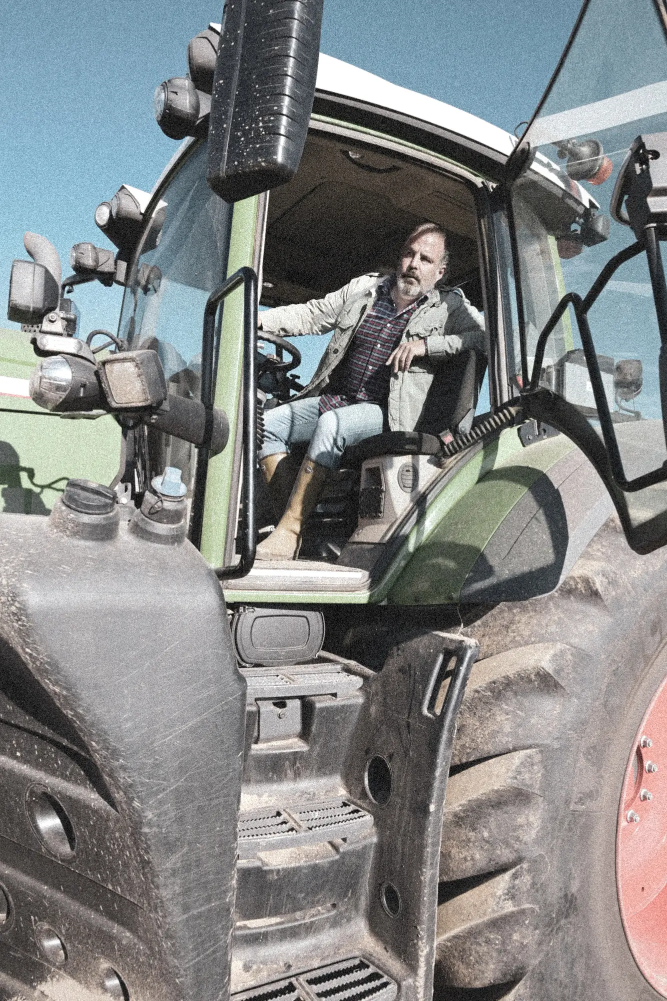 Farmer in the cab of his tractor