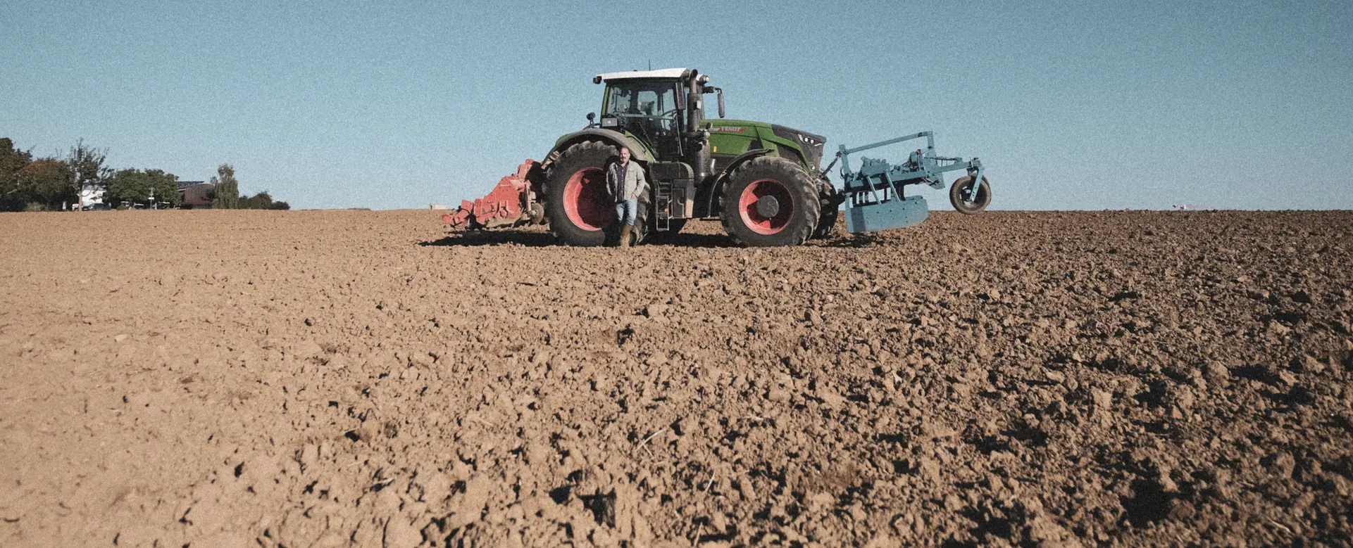 Tractor ploughing a potato field